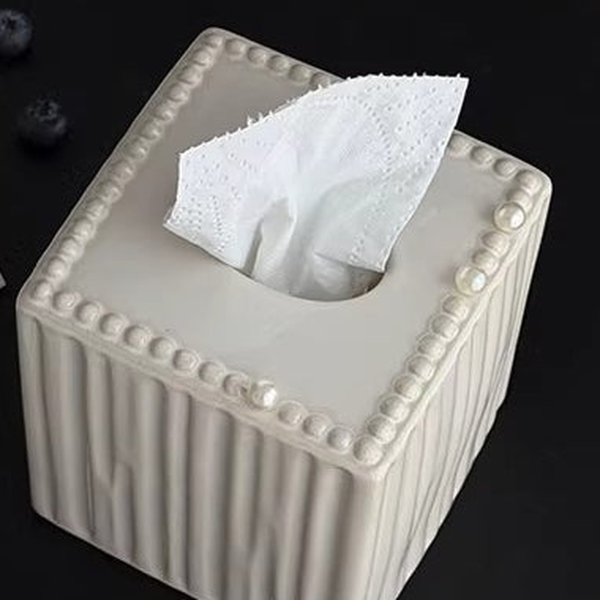 Original close view of the cube cover's pearl trim, ceramic flutes and top tissue opening.