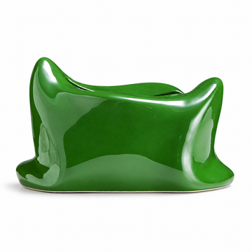 Green pillow-shaped ceramic tissue box cover with a glossy finish and curled corners