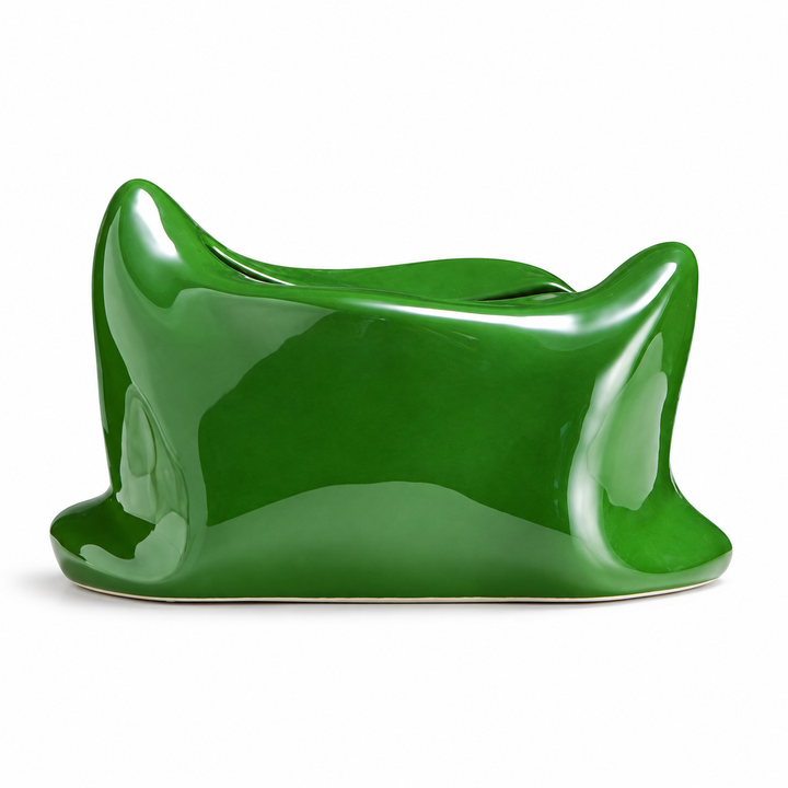 Green pillow-shaped ceramic tissue box cover with a glossy finish and curled corners