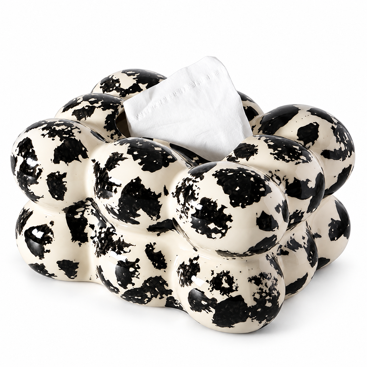 Ivory ceramic tissue box cover with two rows of rounded bubbles and irregular black ink-like patches