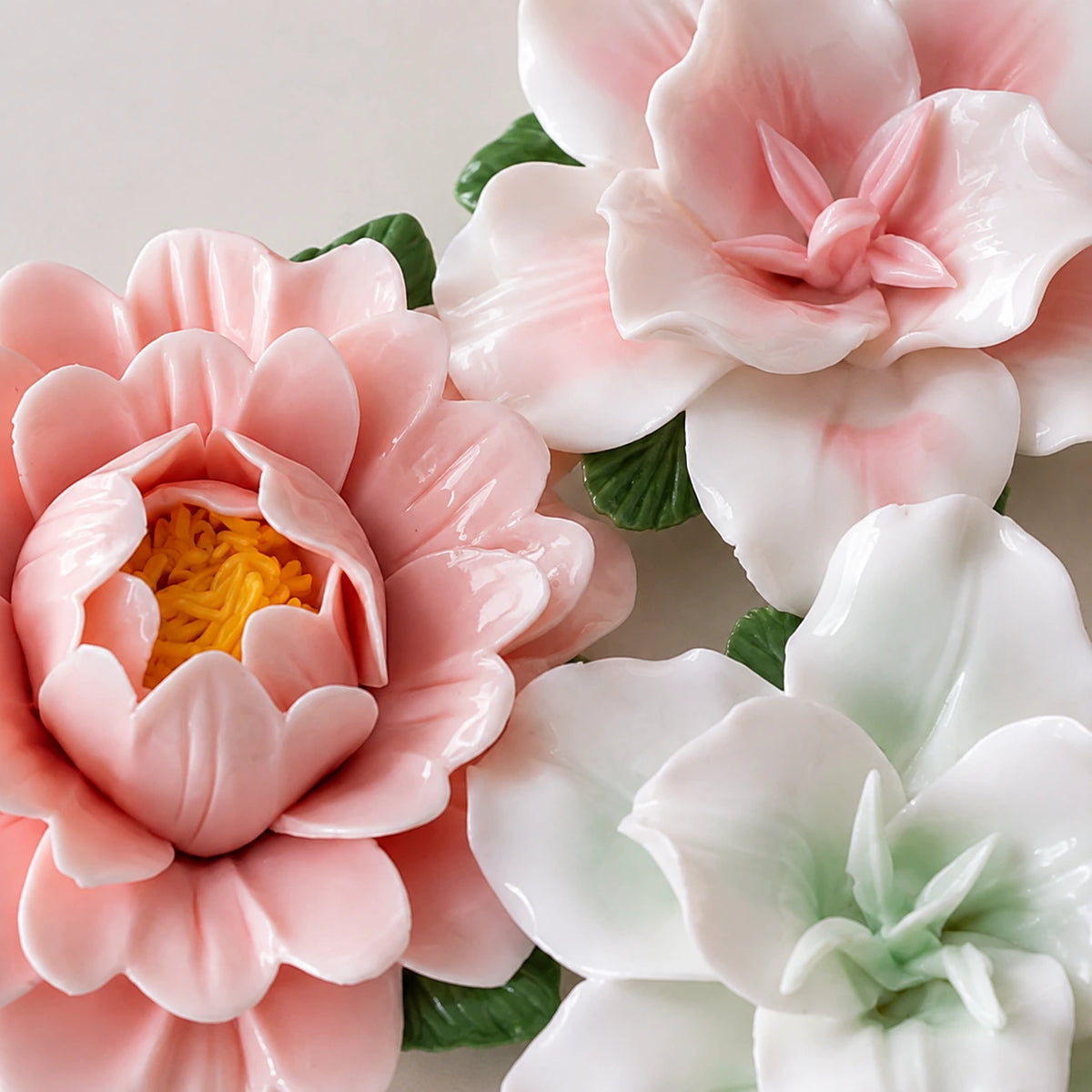 Close-up of the Blush Garden pink peony and pink and pale-green lilies, showing layered glossy ceramic petals.