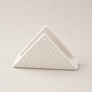 White triangular ceramic napkin holder with dimpled outer panels