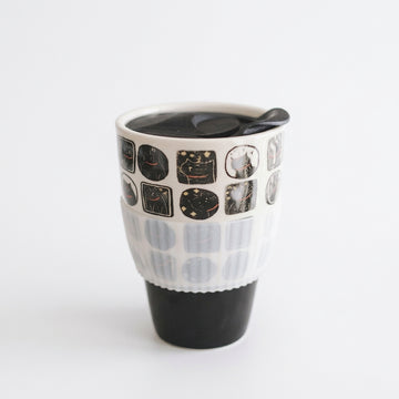 Nocturnal feline ceramic travel mug with black cat panels, black lid and clear sleeve