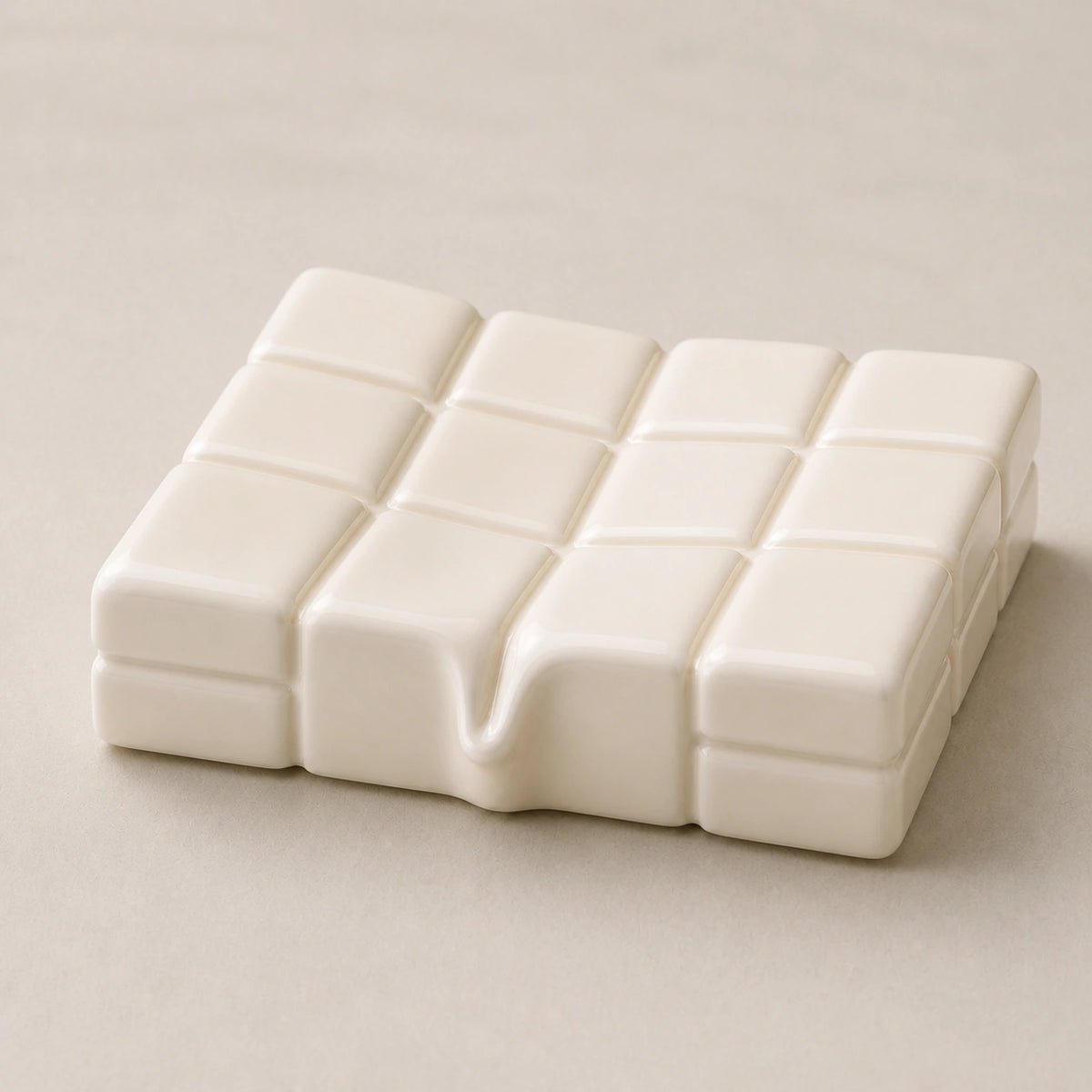 Close view of the glossy milk ceramic shallow basin, twelve tiles, and centered melt detail
