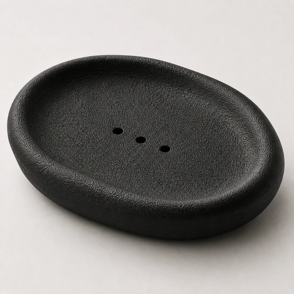Close view of black granular ceramic and three centered openings
