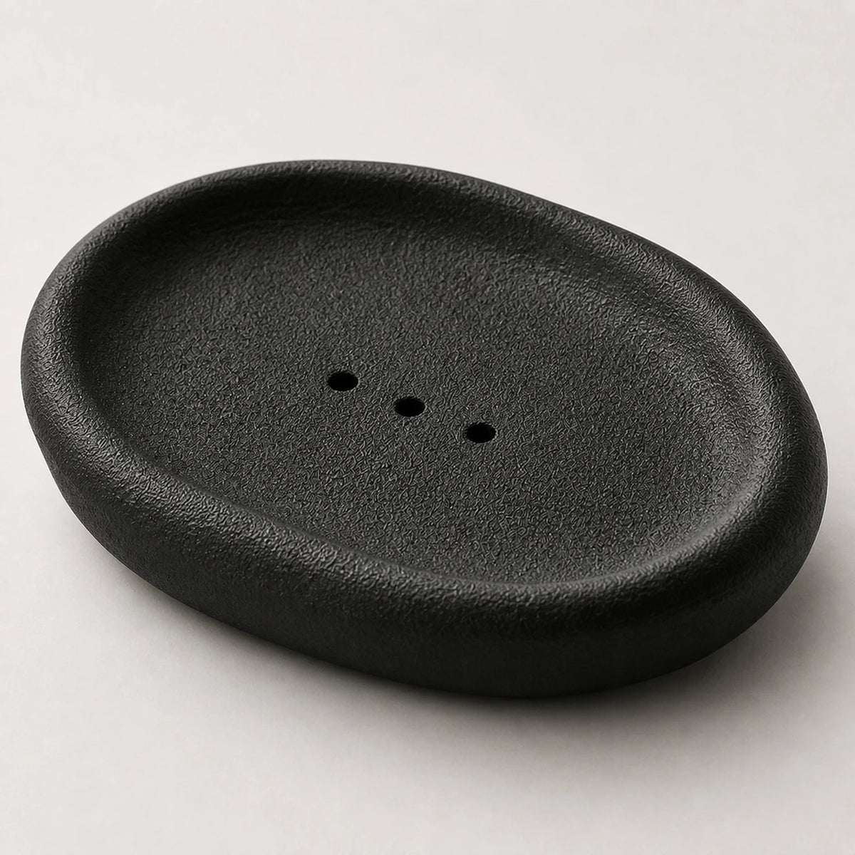 Close view of black granular ceramic and three centered openings