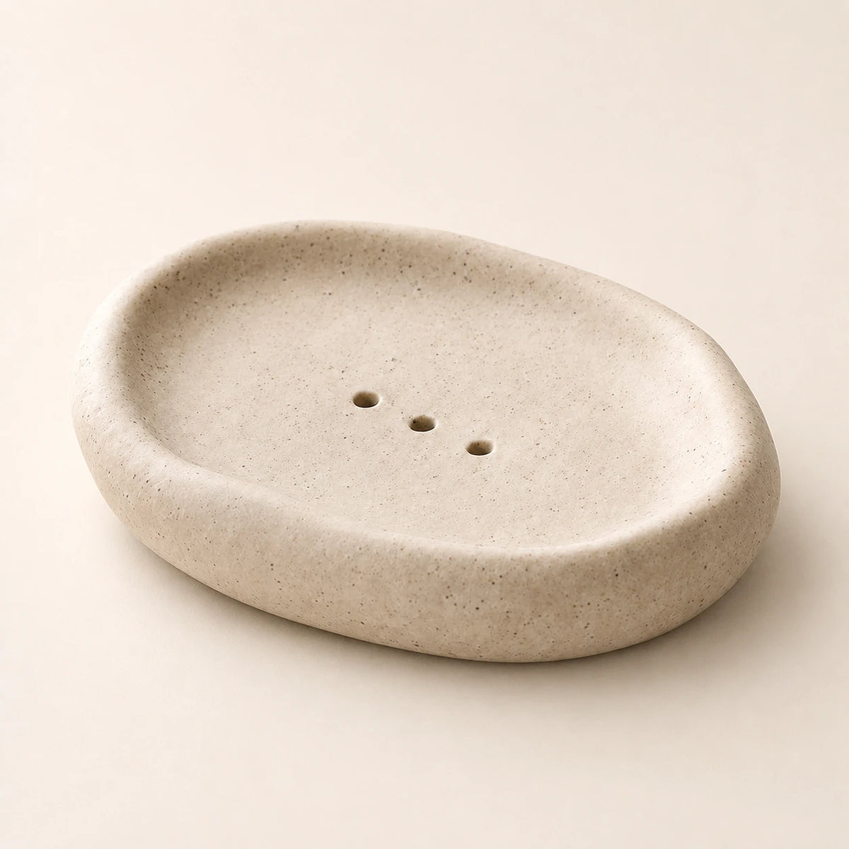 Empty Warm Oat Sand ceramic soap dish on pale warm stone