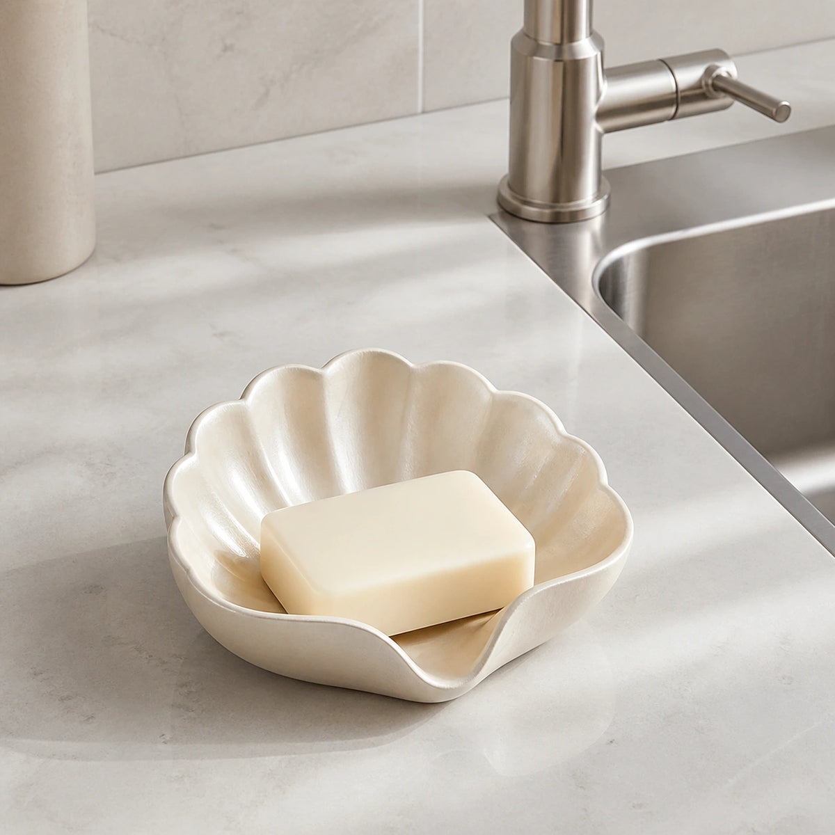 Champagne gold shell soap dish holding a bar of soap beside a kitchen sink