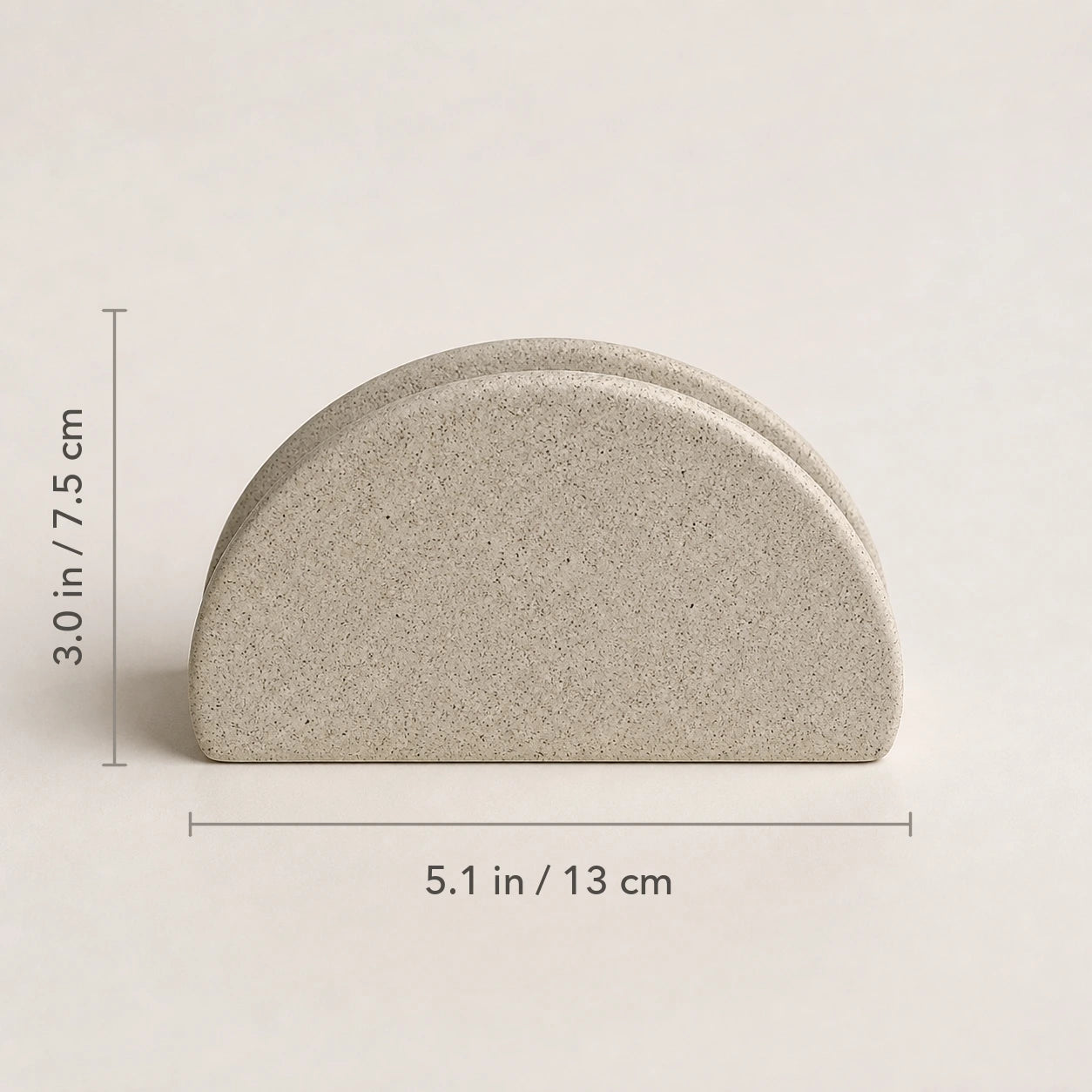 Front view of speckled ceramic napkin holder marked 5.1 inches wide by 3 inches high