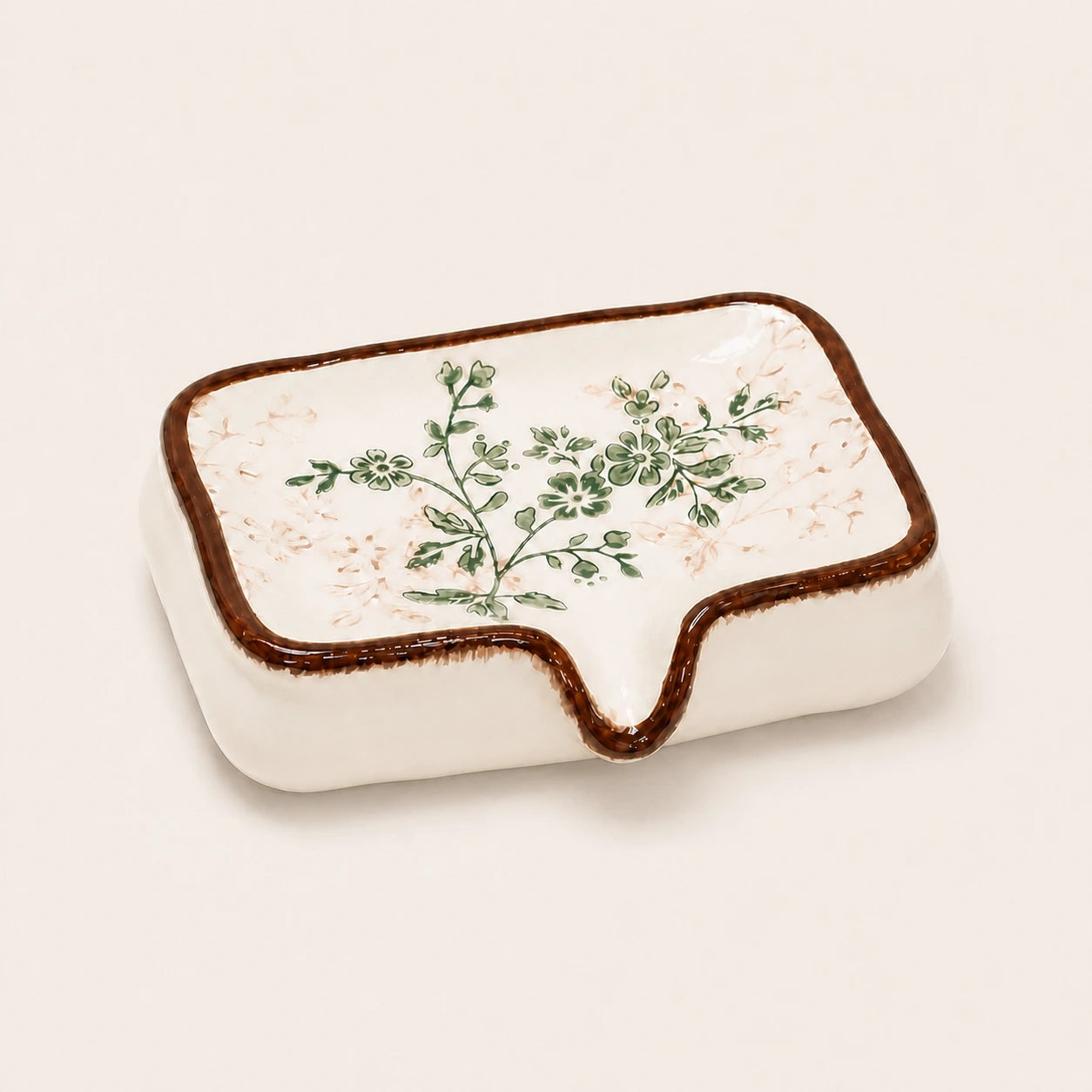 Vintage botanical ceramic soap dish on a warm ivory studio background