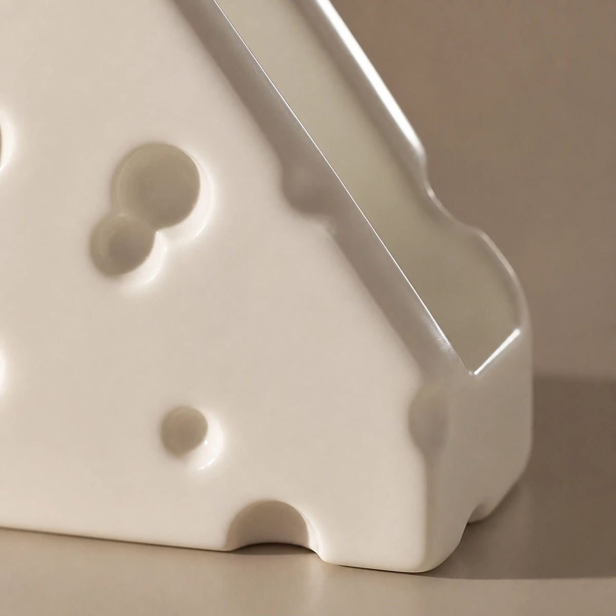 Close view of Alabaster White Swiss Cheese holder showing two panels and one slot