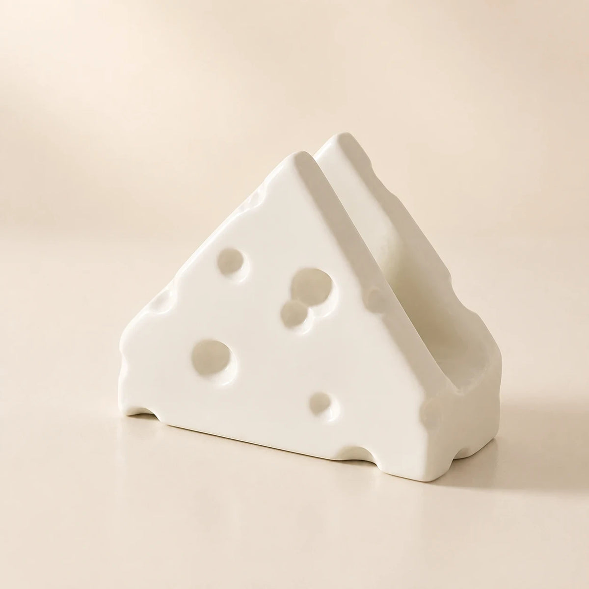 Alabaster White Swiss Cheese ceramic napkin holder in a three-quarter view