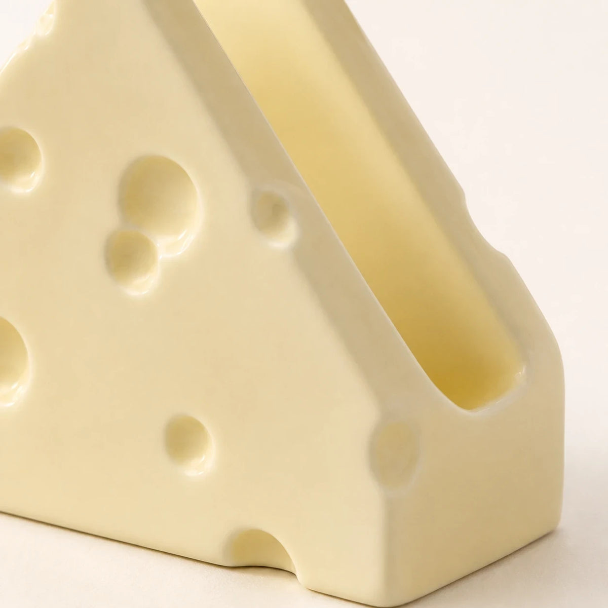 Close view of Butter Cream Swiss Cheese holder showing indentations and its single slot