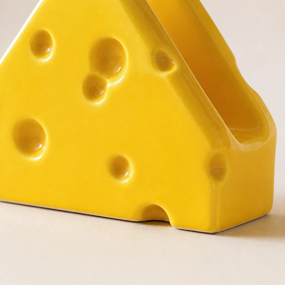 Close view of Classic Yellow Swiss Cheese holder showing round indentations and one slot