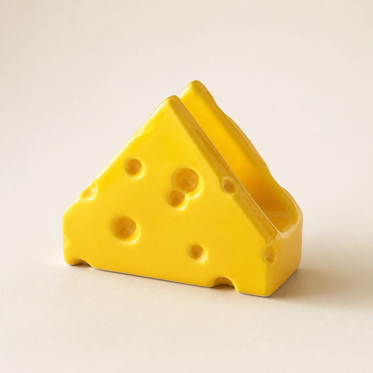 Classic Yellow Swiss Cheese ceramic napkin holder in a three-quarter view