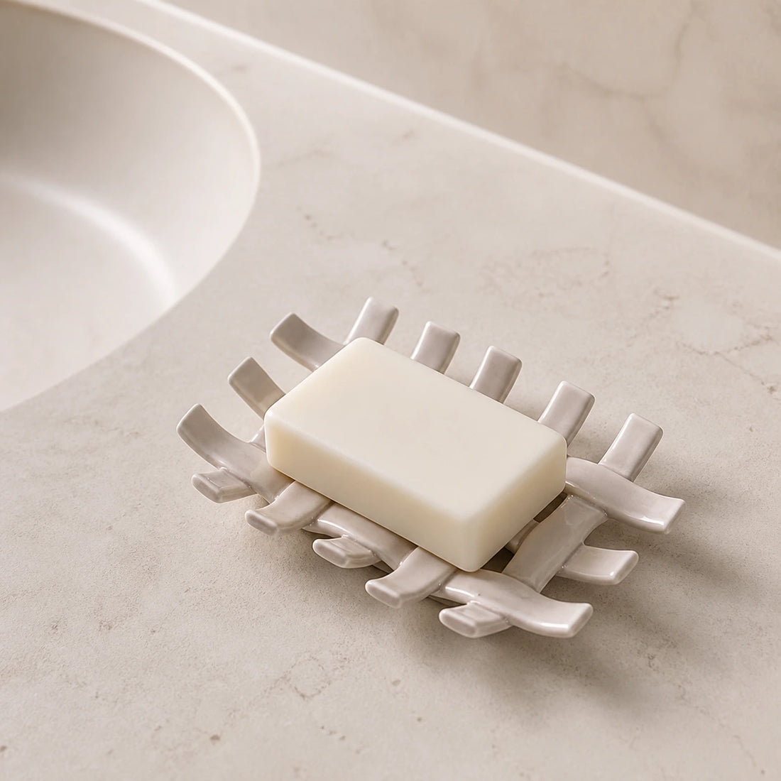 Warm apricot woven ceramic soap dish with a plain soap bar beside a bathroom sink