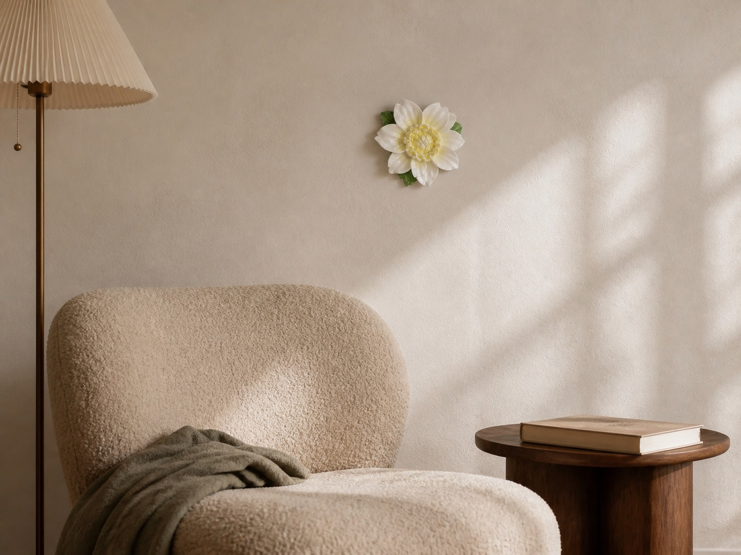 Golden-yellow lotus ceramic wall flower styled above a quiet reading chair.